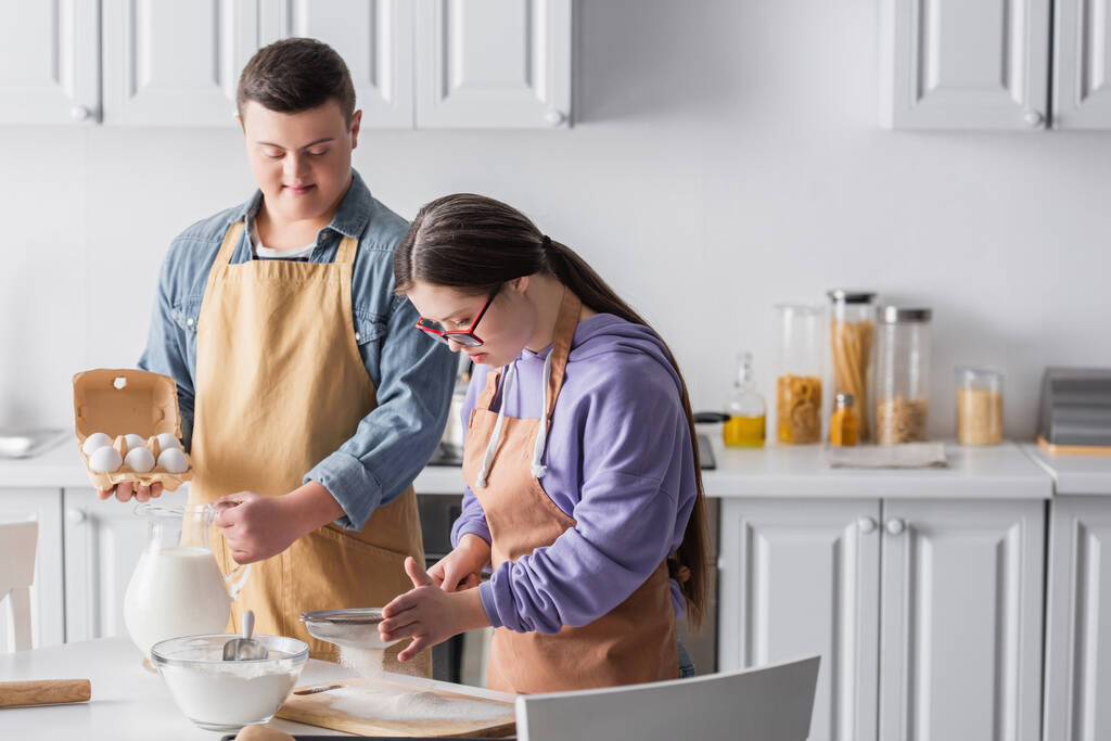 Couple with down syndrome cooking