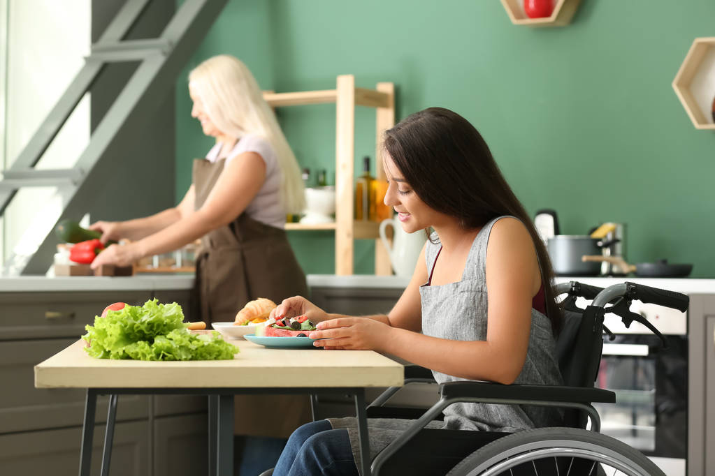 woman in wheelchair eating